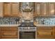 Modern kitchen featuring stainless steel appliances and wood cabinets at 442 Ella Mae Dr, Davenport, FL 33897