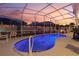 Inviting pool and patio area with screened enclosure, perfect for entertaining at 442 Ella Mae Dr, Davenport, FL 33897