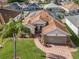 House with solar panels, brick driveway and landscaped yard at 442 Ella Mae Dr, Davenport, FL 33897