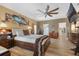 Bright bedroom featuring a comfy bed, ample closet space, and wood floors at 442 Ella Mae Dr, Davenport, FL 33897