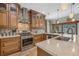 Spacious kitchen with wood cabinets, stainless steel appliances, and granite countertops at 442 Ella Mae Dr, Davenport, FL 33897
