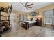 Well-lit bedroom with wood floors and a ceiling fan at 442 Ella Mae Dr, Davenport, FL 33897