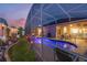 Lush landscaping surrounds this screened pool and patio area at 442 Ella Mae Dr, Davenport, FL 33897