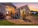 Evening view of home's exterior, showcasing a brick walkway and landscaping at 442 Ella Mae Dr, Davenport, FL 33897