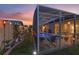 Landscaped backyard with a pool and screened enclosure at 442 Ella Mae Dr, Davenport, FL 33897