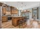 Open kitchen with island, stainless steel appliances, and wood cabinets at 442 Ella Mae Dr, Davenport, FL 33897