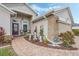Home exterior with brick walkway, landscaping, and a two-car garage at 442 Ella Mae Dr, Davenport, FL 33897