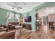 Living room with brown leather furniture and hardwood floors at 442 Ella Mae Dr, Davenport, FL 33897