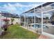 Screened pool area with lush landscaping and a spacious deck at 442 Ella Mae Dr, Davenport, FL 33897