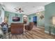 Open living room with leather furniture and hardwood floors at 442 Ella Mae Dr, Davenport, FL 33897