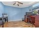 Home office featuring wood floors, built-in desk, and ample workspace at 442 Ella Mae Dr, Davenport, FL 33897