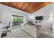 Living room with wood-beamed ceilings, comfy sofa, and access to balcony at 200 Maitland Ave # 20, Altamonte Springs, FL 32701