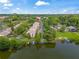 Aerial view of condo community by the lake featuring boat docks and lush greenery at 200 Maitland Ave # 20, Altamonte Springs, FL 32701