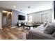 Spacious living room with grey sectional and wood floors at 5300 Oakbourne Ave, Davenport, FL 33837