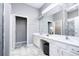 Modern bathroom with double vanity, white cabinets and marble flooring at 5300 Oakbourne Ave, Davenport, FL 33837