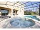 Large hot tub with surrounding patio and lounge chairs at 5300 Oakbourne Ave, Davenport, FL 33837