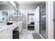 Elegant bathroom with double vanity, large mirror, and a walk-in shower at 5300 Oakbourne Ave, Davenport, FL 33837