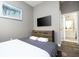 Comfortable bedroom with a bed, dresser, and ensuite bathroom at 5300 Oakbourne Ave, Davenport, FL 33837