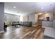 Spacious living room with gray sectional sofa and wood-look floors at 5300 Oakbourne Ave, Davenport, FL 33837
