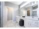Double vanity bathroom with a large mirror and an adjacent toilet area at 5300 Oakbourne Ave, Davenport, FL 33837