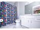 Bathroom with white vanity, toilet and Marvel-themed shower curtain at 5300 Oakbourne Ave, Davenport, FL 33837