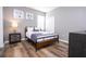 Bright bedroom with a comfortable bed and wood-look floors at 5300 Oakbourne Ave, Davenport, FL 33837