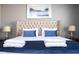 Main bedroom with king-size bed and beige upholstered headboard at 5300 Oakbourne Ave, Davenport, FL 33837