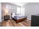 Cozy bedroom with a full-size bed and wood-look floors at 5300 Oakbourne Ave, Davenport, FL 33837