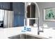 Modern kitchen sink with a sleek faucet and white countertops at 5300 Oakbourne Ave, Davenport, FL 33837