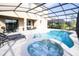 Inviting pool and spa with covered patio and lounge chairs at 5300 Oakbourne Ave, Davenport, FL 33837