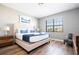 Main bedroom with a queen-size bed and wood-look floors at 5300 Oakbourne Ave, Davenport, FL 33837