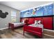 Mickey Mouse themed bedroom with twin beds and a fun wall mural at 5300 Oakbourne Ave, Davenport, FL 33837