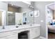 Large bathroom with double vanity, white cabinets and a walk-in shower at 5300 Oakbourne Ave, Davenport, FL 33837