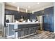 Modern kitchen with dark cabinetry, stainless steel appliances and an island at 5300 Oakbourne Ave, Davenport, FL 33837