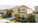 Two-story house on a tree-lined street with a tan exterior and tile roof at 5300 Oakbourne Ave, Davenport, FL 33837