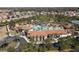 Community clubhouse with pool and surrounding homes at 5300 Oakbourne Ave, Davenport, FL 33837