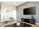 Relaxing living room featuring hardwood floors, a mounted TV, and comfortable seating at 5300 Oakbourne Ave, Davenport, FL 33837