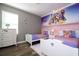 Two twin beds in a themed bedroom with Disney Princess wall art at 5300 Oakbourne Ave, Davenport, FL 33837