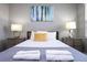 Double bed in a bedroom with wood nightstands and wall art at 5300 Oakbourne Ave, Davenport, FL 33837