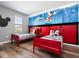 Mickey Mouse-themed bedroom with twin beds and wood-look floors at 5300 Oakbourne Ave, Davenport, FL 33837