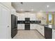 Modern kitchen with white cabinets, stainless steel appliances and a spacious layout at 8834 Cabot Cliffs Dr, Davenport, FL 33896