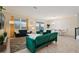 Living room with green sofas, large TV, and natural light at 8834 Cabot Cliffs Dr, Davenport, FL 33896