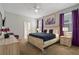 Bright bedroom featuring a king-size bed, large windows, and stylish decor at 8834 Cabot Cliffs Dr, Davenport, FL 33896
