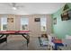 Game room with pool table, play area and window views at 8834 Cabot Cliffs Dr, Davenport, FL 33896