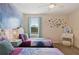 Twin bedroom with Frozen wall mural and playful decor at 8834 Cabot Cliffs Dr, Davenport, FL 33896