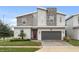 Two-story modern home with stone accents and two-car garage at 8834 Cabot Cliffs Dr, Davenport, FL 33896