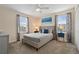 Bedroom with a queen bed, blue accents and plenty of natural light at 8834 Cabot Cliffs Dr, Davenport, FL 33896