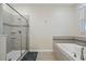 Clean bathroom with a walk-in shower and a relaxing bathtub at 8834 Cabot Cliffs Dr, Davenport, FL 33896