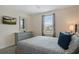Bedroom with a queen bed, dresser, and a large mirror at 8834 Cabot Cliffs Dr, Davenport, FL 33896