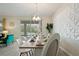 Elegant dining room with a large table, modern chandelier, and pool view at 8834 Cabot Cliffs Dr, Davenport, FL 33896